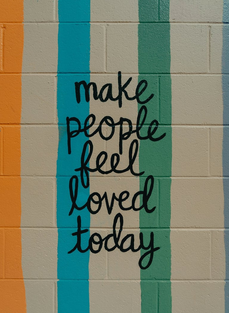 a wall with a quote on it 'make people feel loved'.
