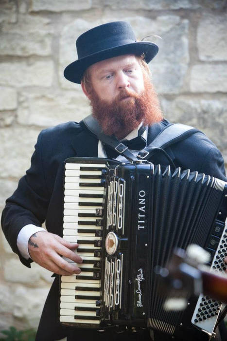Band member playing accordion during a live performance with Mazel Tov Kocktail Hour