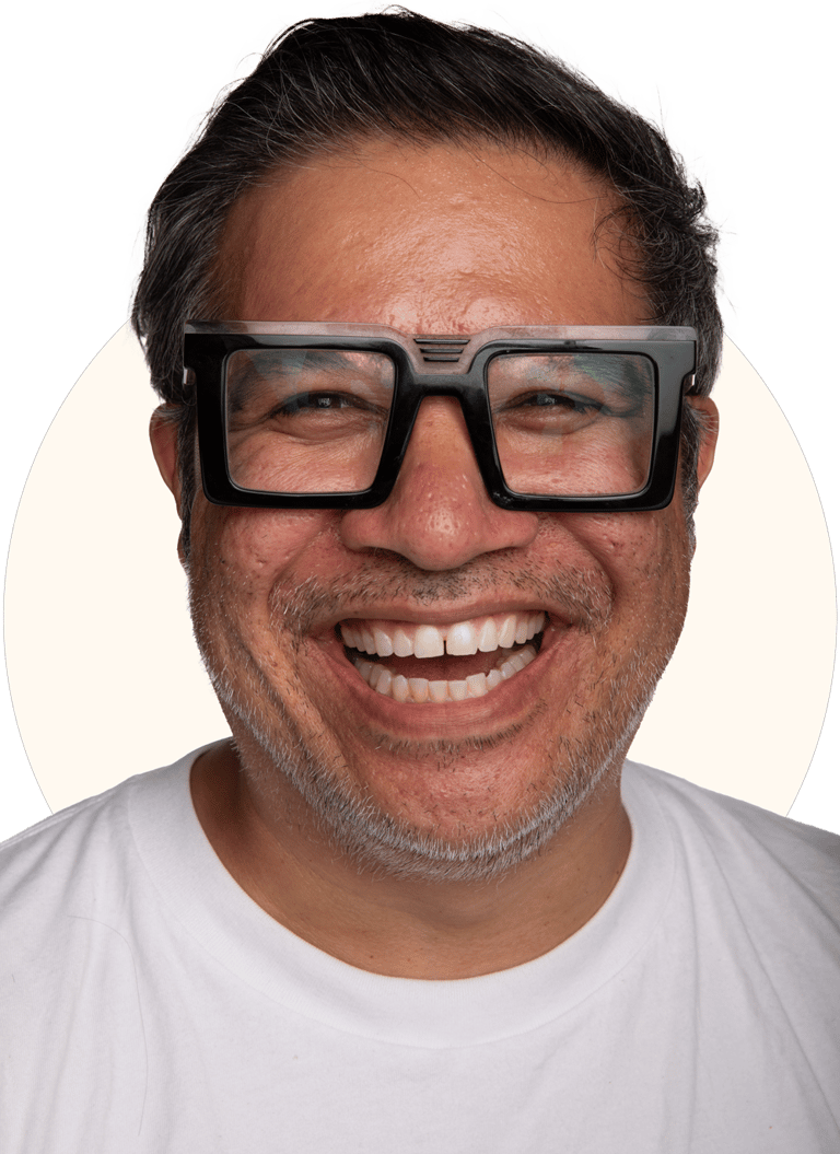Tio Toto - smiling with black rim glasses and a white shirt