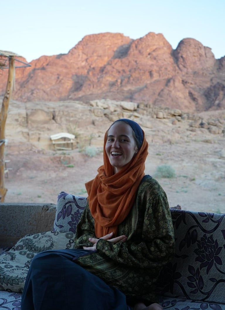 Woman smiling with a backdrop of mountains