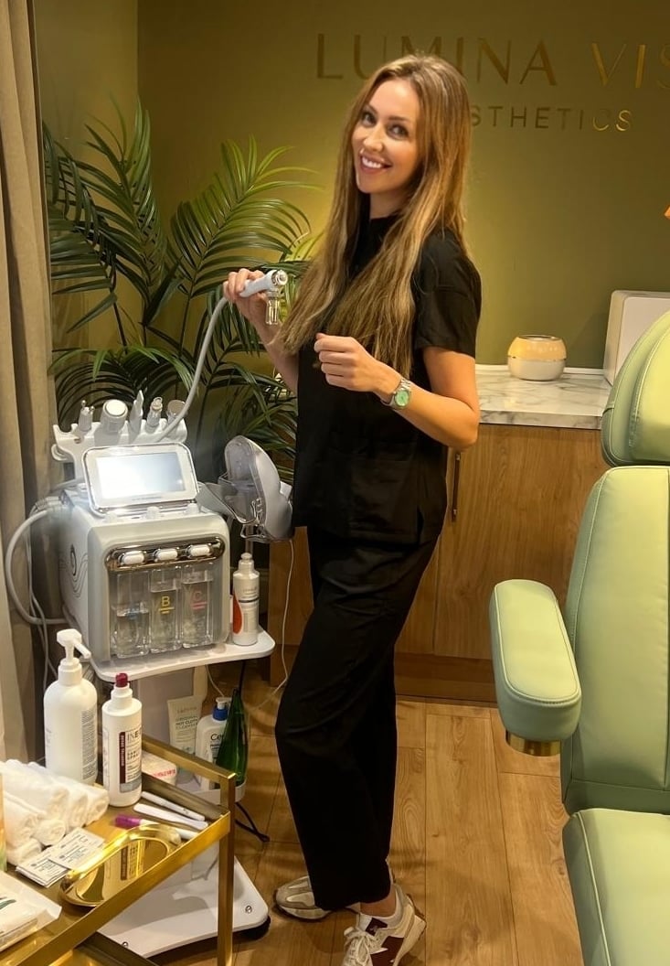 a woman in a black dress standing in a salon