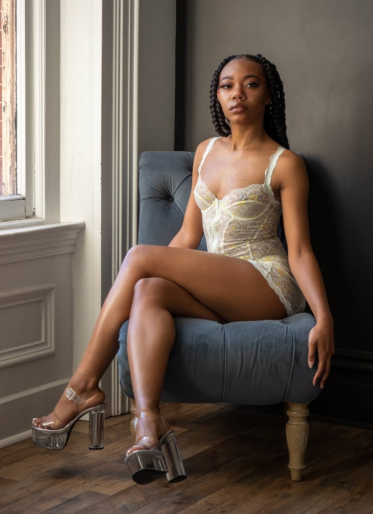 a woman in white lace bodysuit and high heels