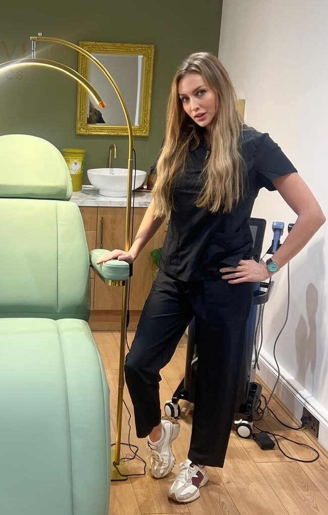 a woman standing in front of a chair