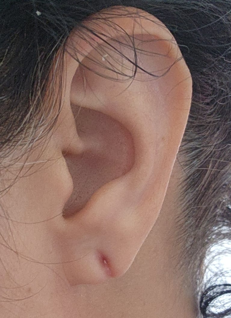 a woman with a piercing on her ear