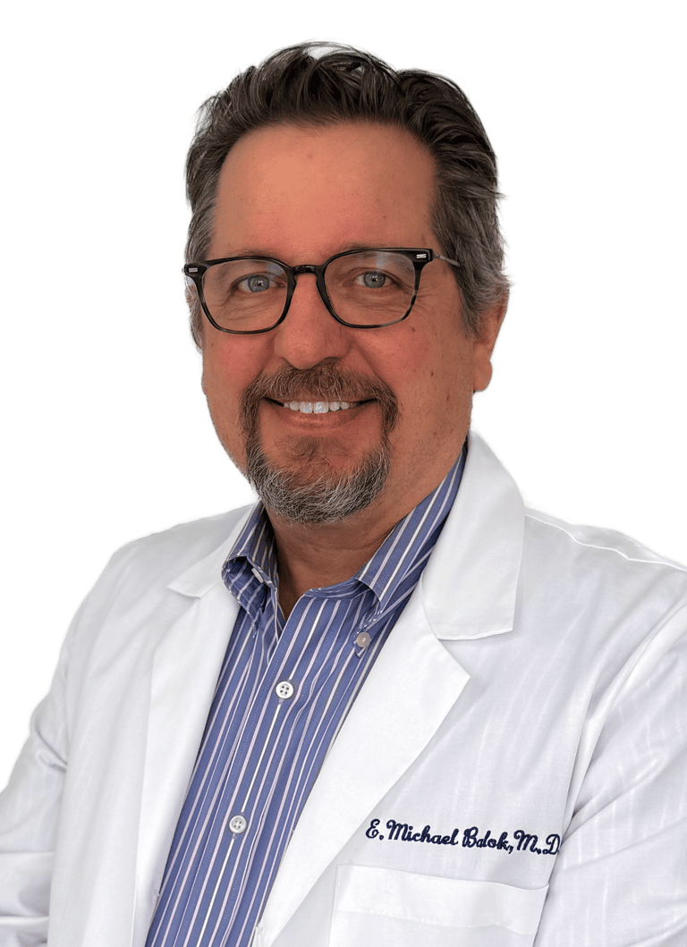 man in a white lab coat wearing glasses