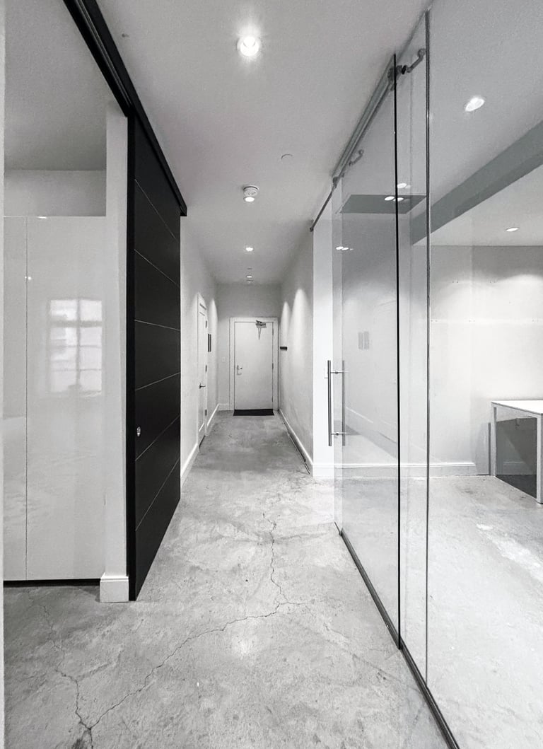 Minimal contemporary condo in progress, concrete floors, glass partition, South End Boston, Erica Fossati Design