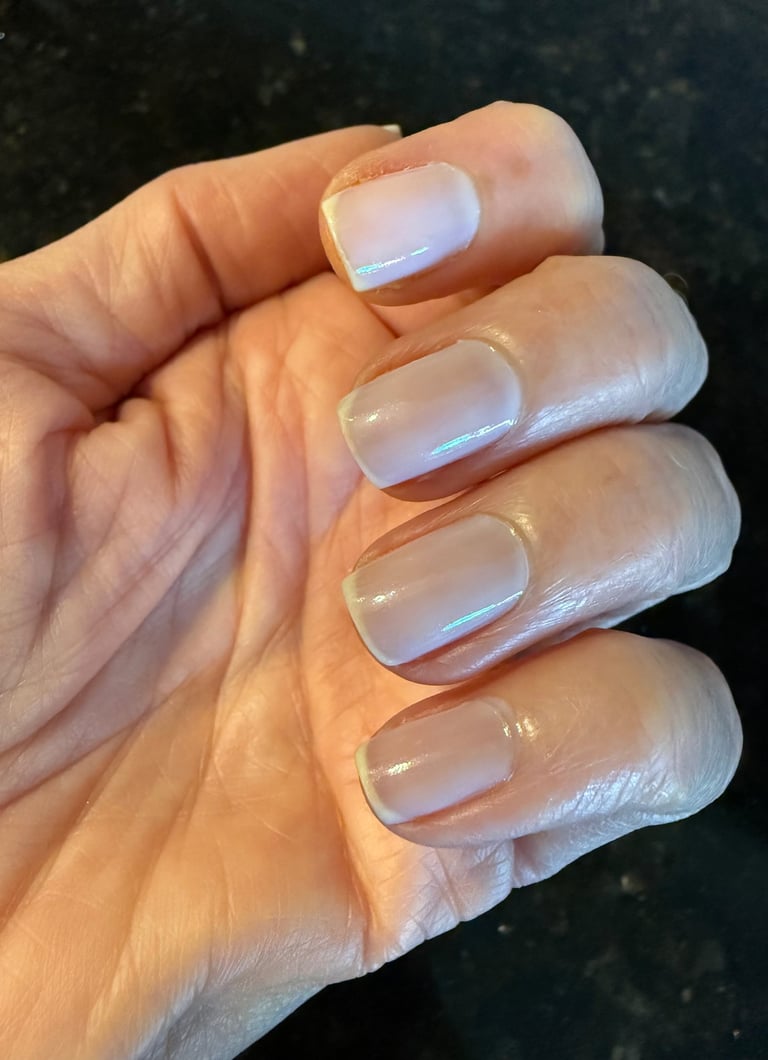 One coat of sheer nail polish giving a clean, natural, healthy looking finish on the nails.