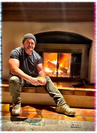 Alfred, co-owner of Green Bee Laser Cleaning & Restoration, relaxing by a fireplace