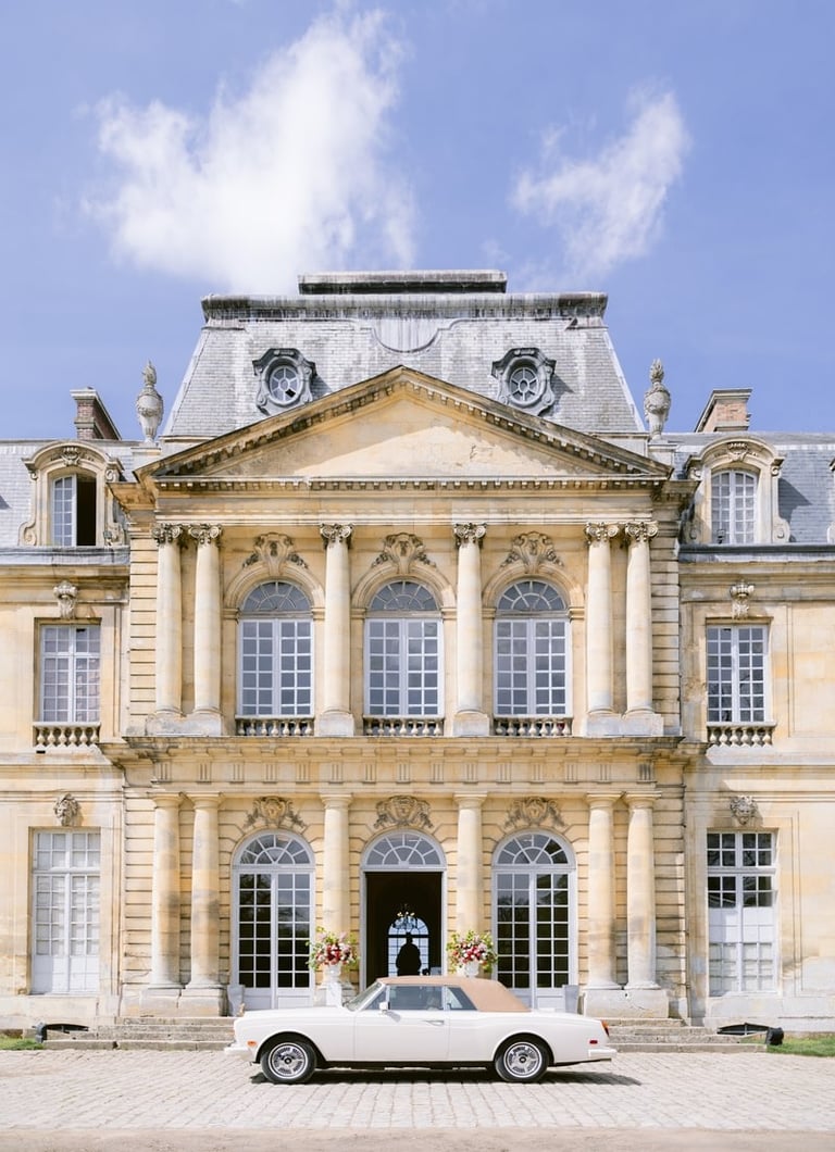 main entry at chateau de champlatreux with luxury car for the wedding
