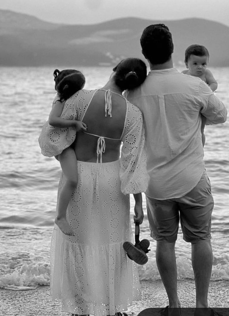A couple doing couples therapy on the beach with their kids at hand