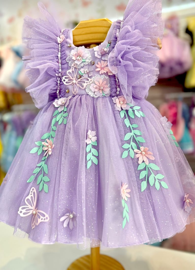 Purple butterfly tulle flower girl dress with 3D floral appliqués and ruffled sleeves.
