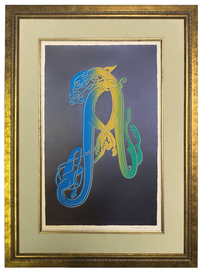 A black handprinted Irish Celtic letter A in a gold frame