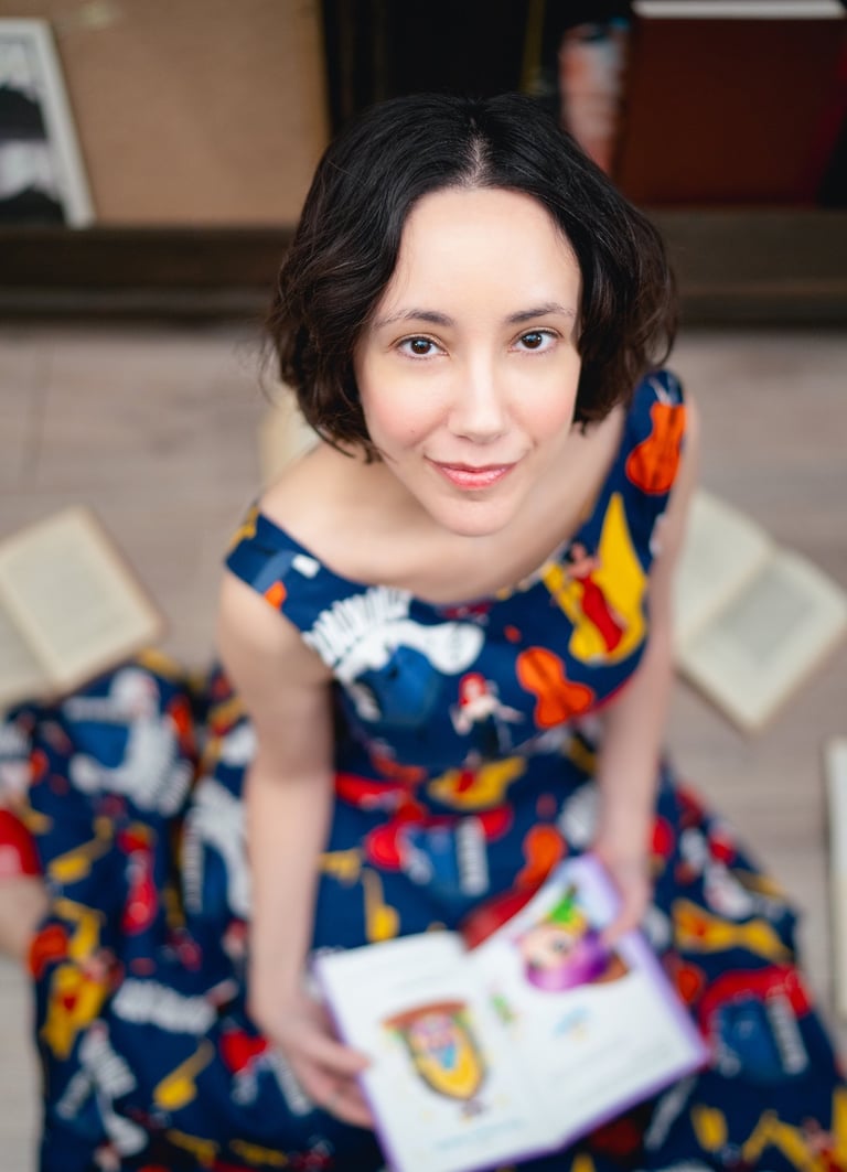 Maria is sitting on the floor with an open book on her lap