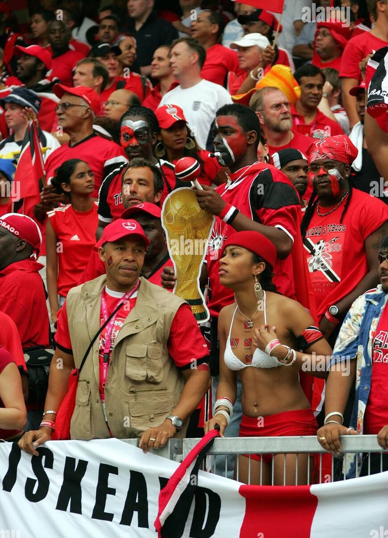 Fans of Trinidad and Tobago Soca Warriors celebrating with trophy at a football event.