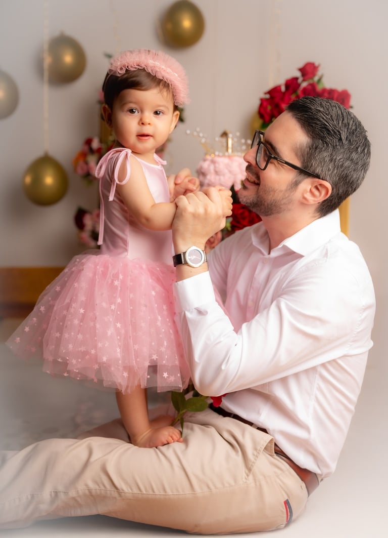 a man and a little girl in a pink dress