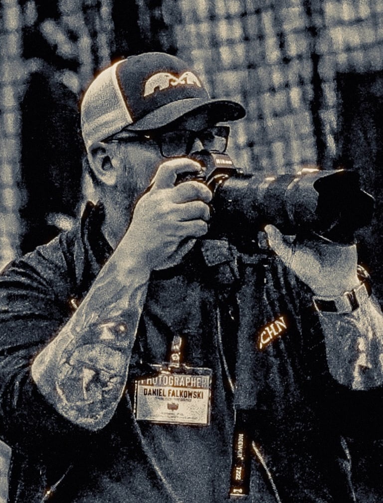 A photo of Dan Falkowski of DanFalk Designs holding a camera
