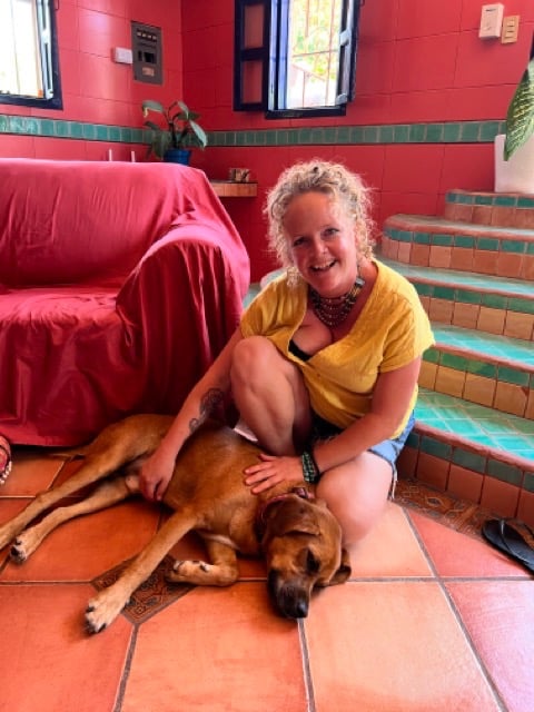 Sunni Dawson smiling with Labrador after animal communication session