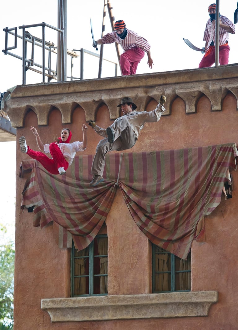 a woman and man jumping off a roof