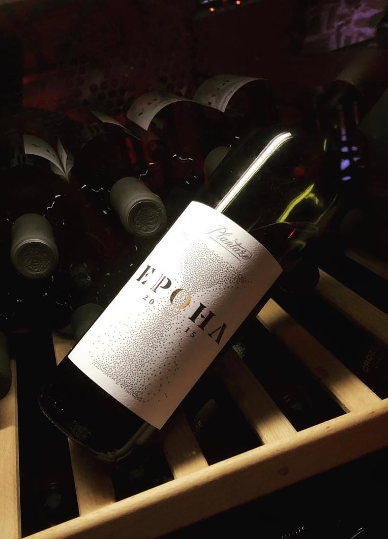 a bottle of wine is sitting on a wooden crate
