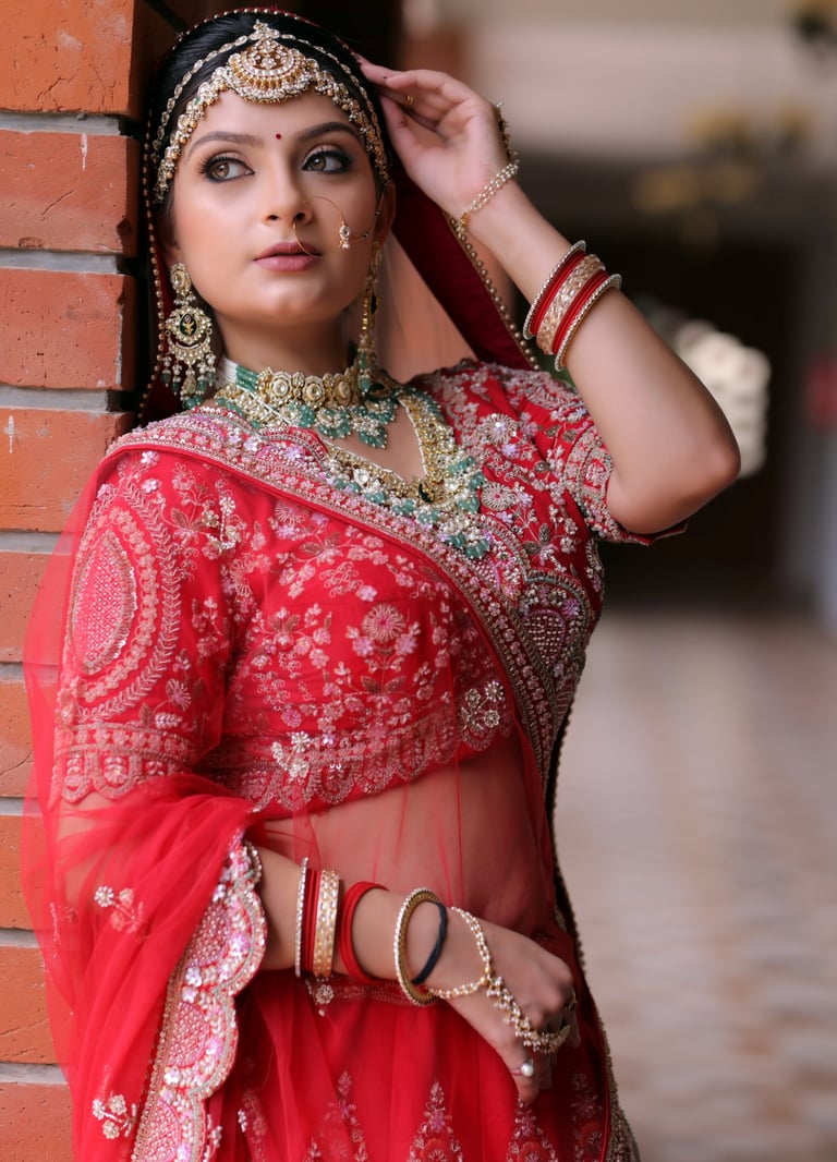 “Gorgeous traditional bride in red saree style lehenga, adorned with kundan jewelry, maang tikka, 