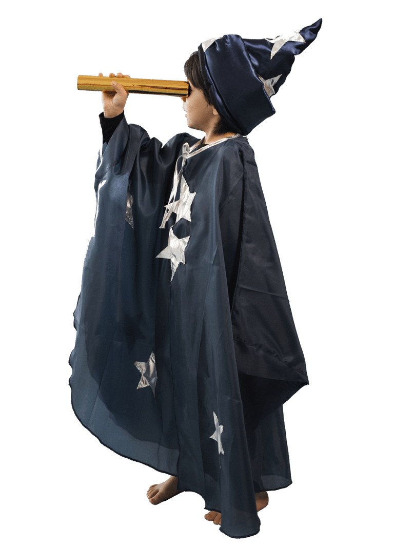 Young boy dressed like a wizard looking at the stars