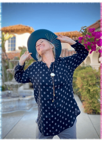 Kandace, co-owner of Green Bee Laser Cleaning & Restoration, smiling by a garden fountain