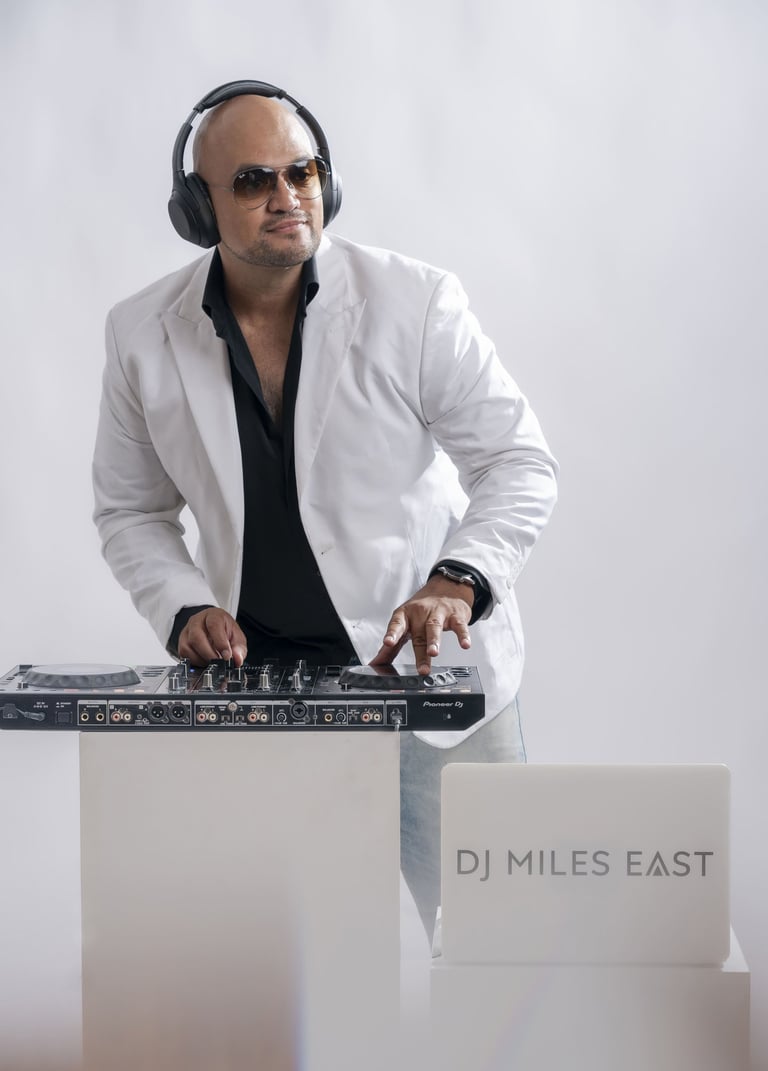 a dj in a white jacket and headphones