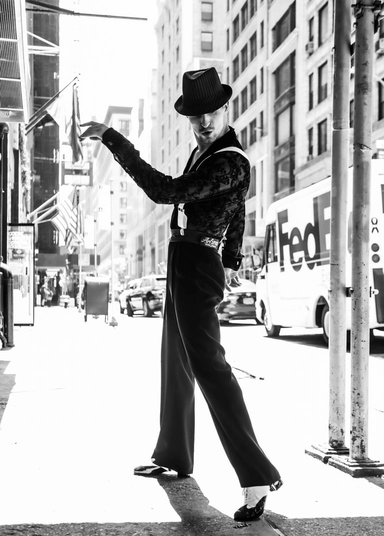 A man in a cool costume with a hat posing in NYC