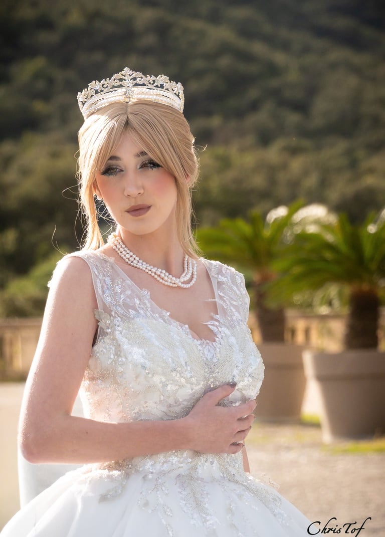 jeune fille en robe de mariée , regard pensif devant le chateau de Valmy à argeles 66