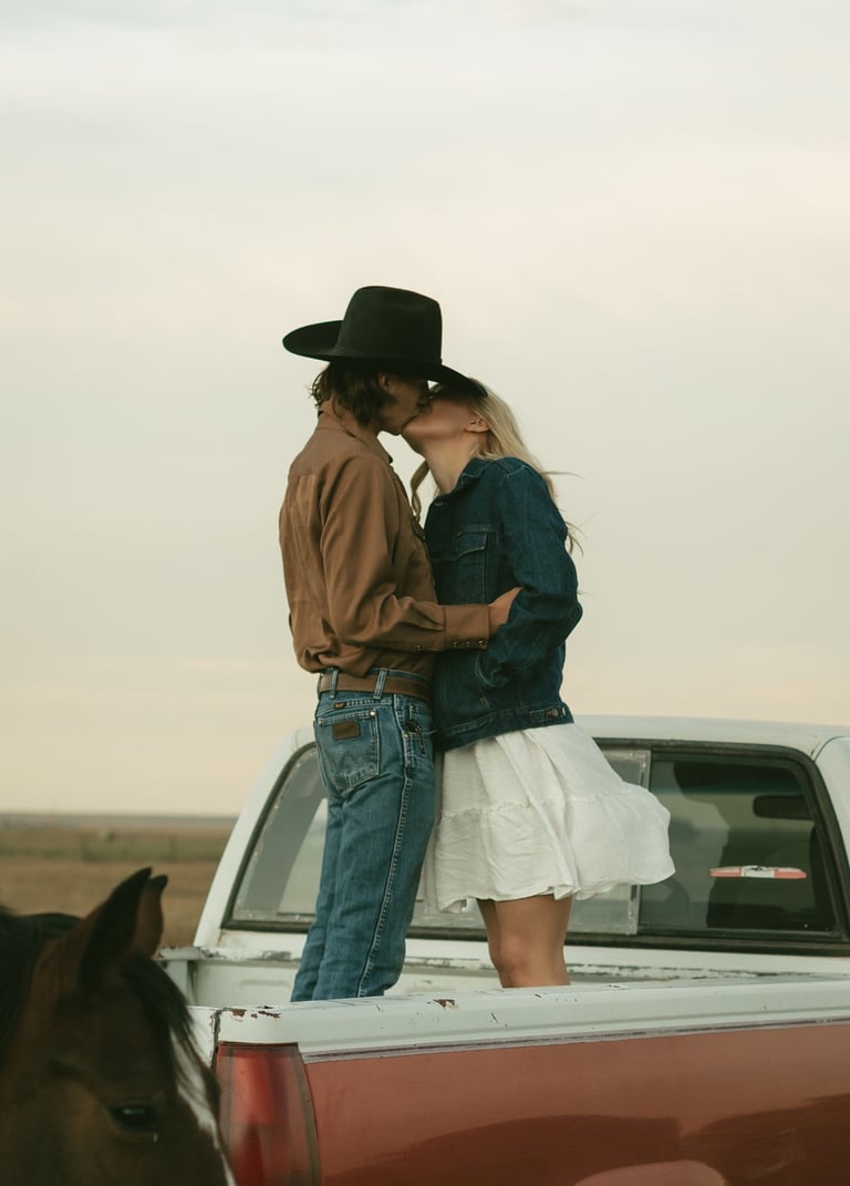 a man and woman kissing in the back of a truck