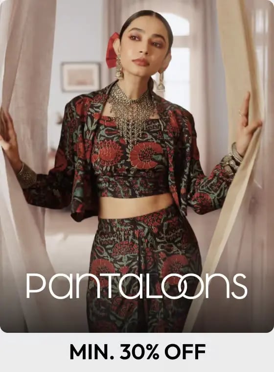 Model wearing a printed Pantaloons ethnic co-ord set with a cropped jacket and traditional silver jewelry.