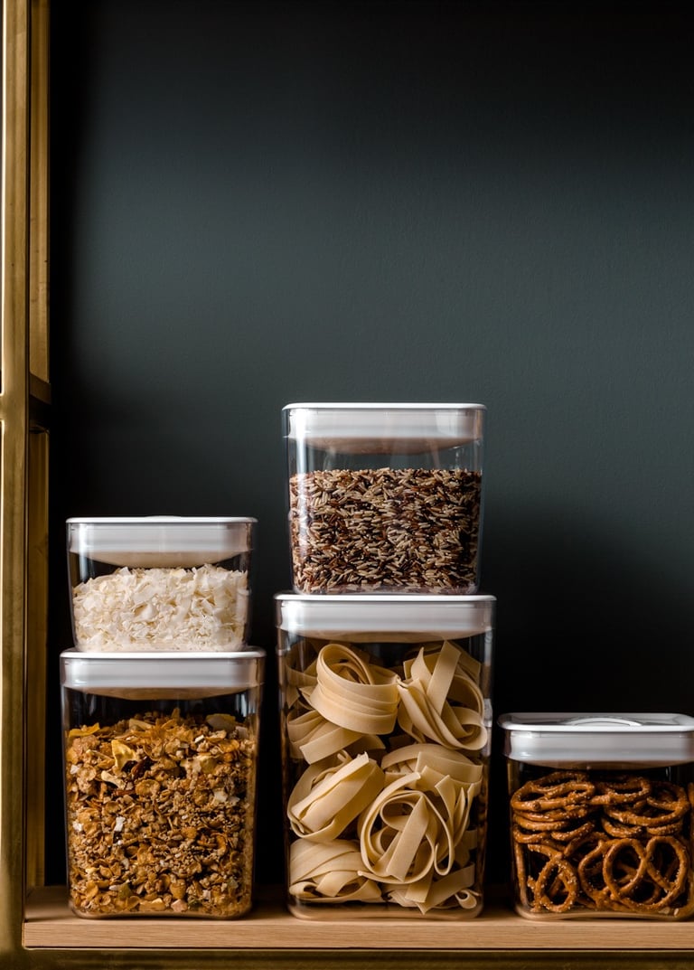 Food product photography - a shelf with several containers of food and nuts