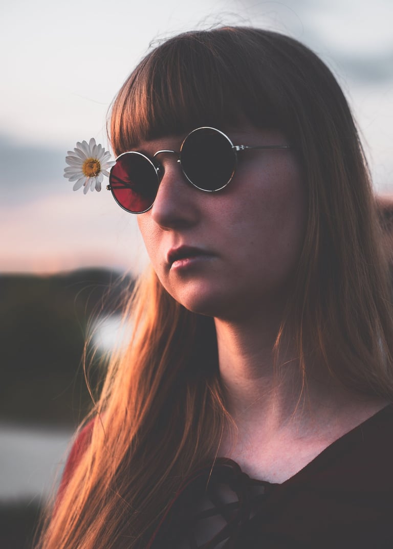 a woman with sunglasses on her face during sunset