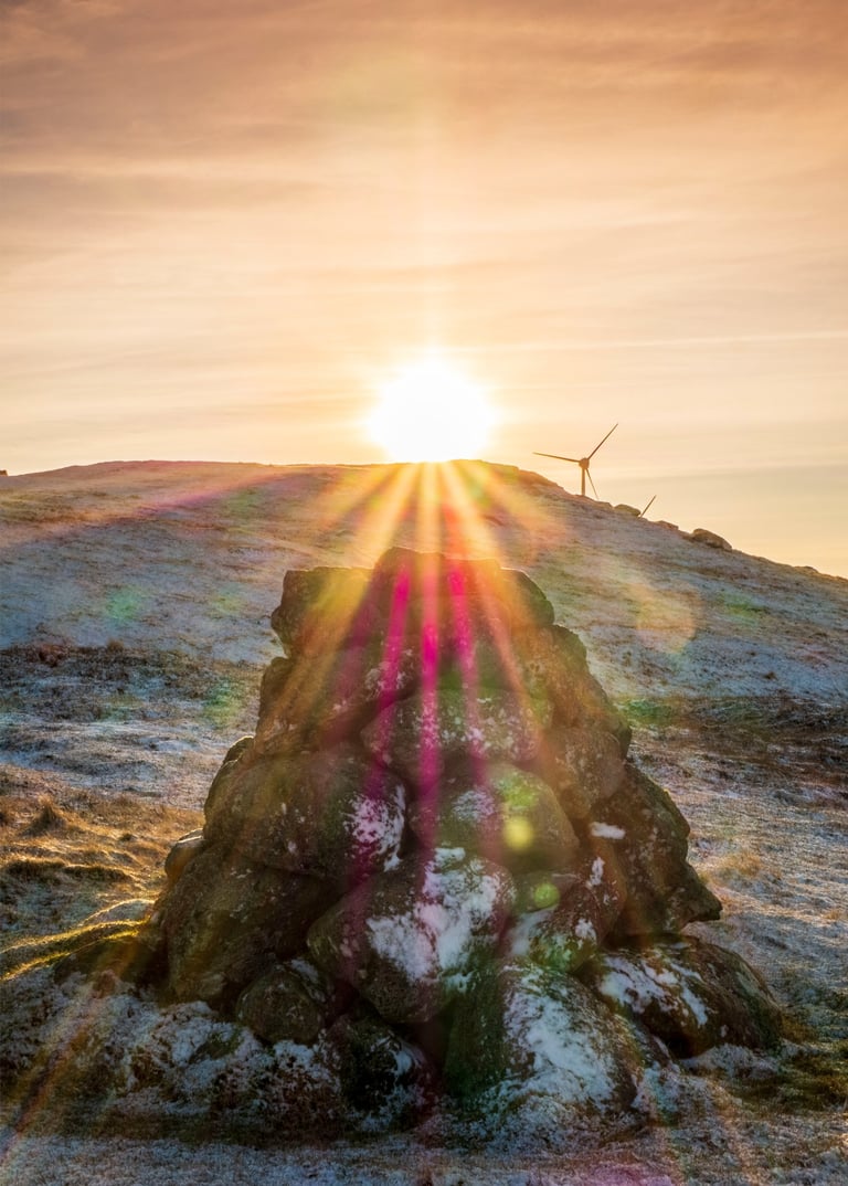 A cairn in the Faroe Islands during sunset