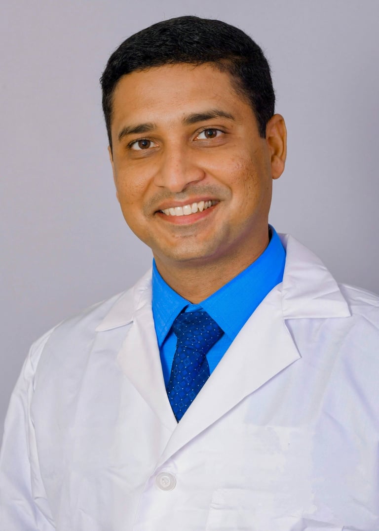 a man in a lab coat and tie dyes a blue tie