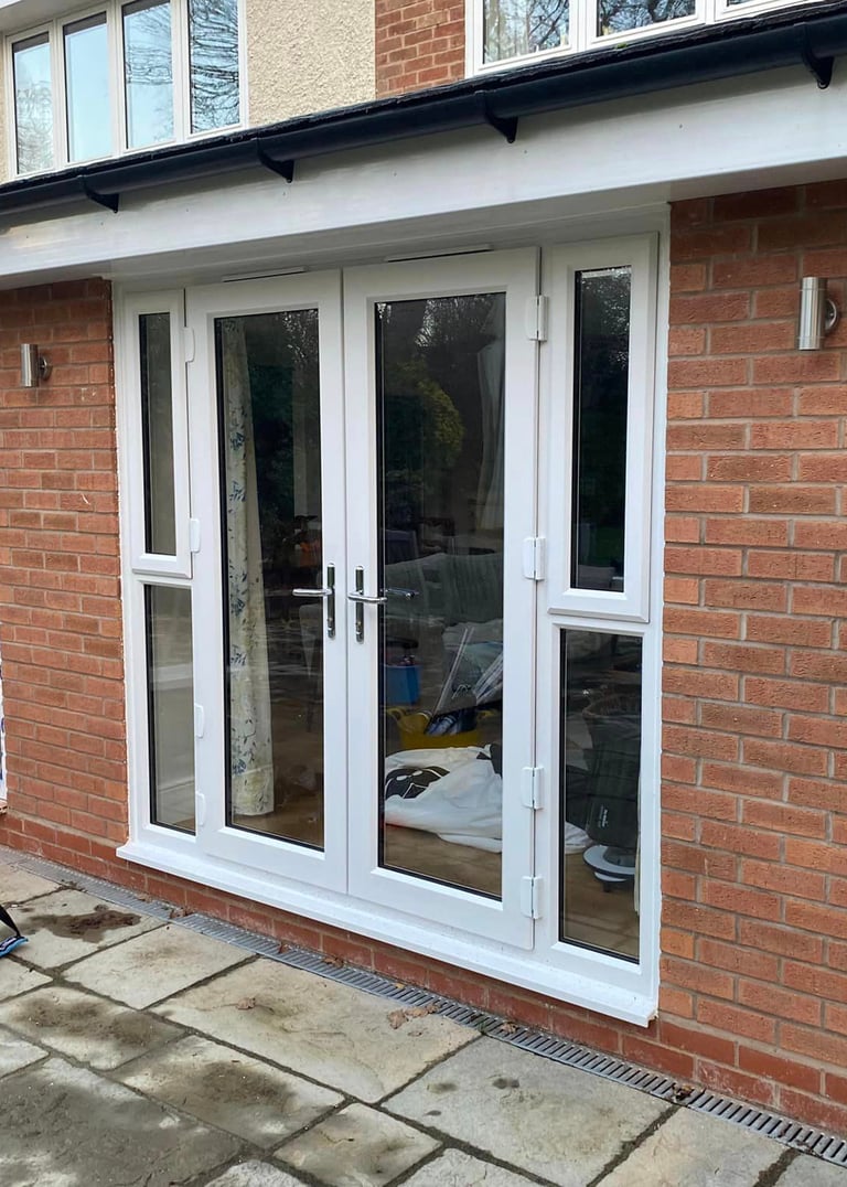 french doors fitted into brickwork and patio