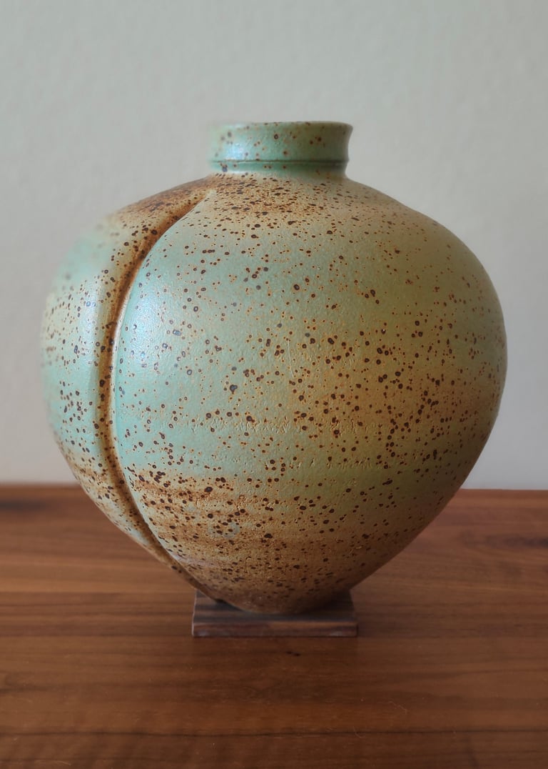 wheel-thrown and altered vase, spray-glazed with a base coat of green and top coat of earthy brown