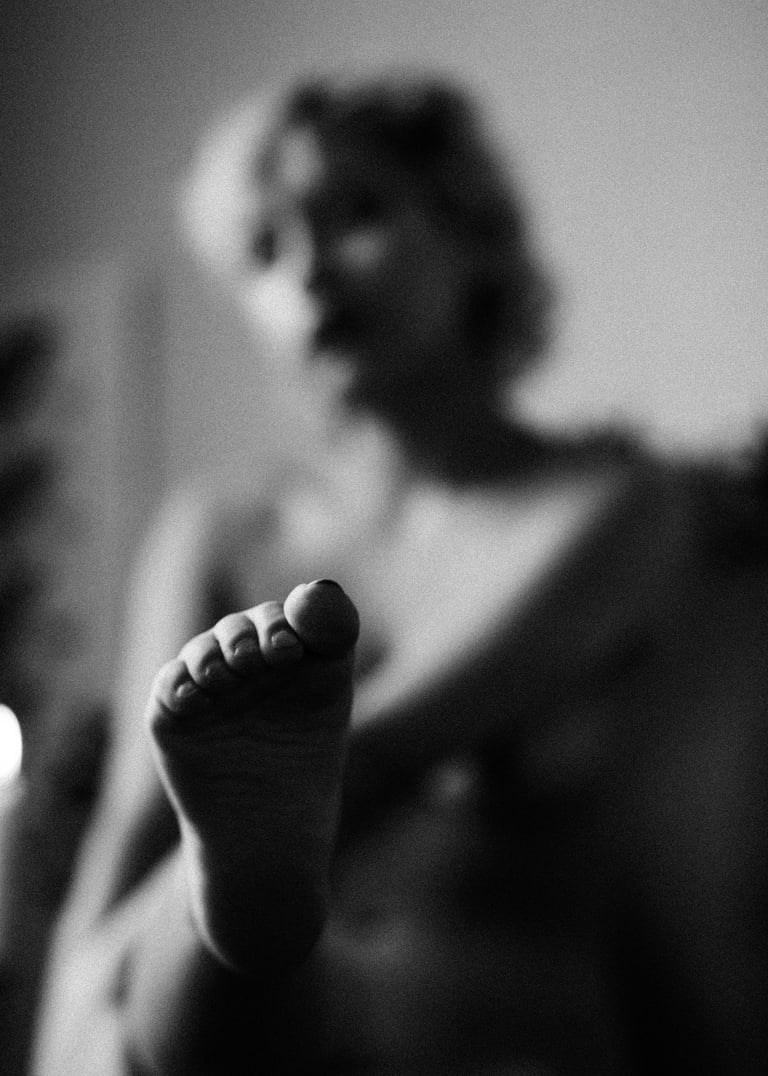 a woman's feet and toes are shown in black and white