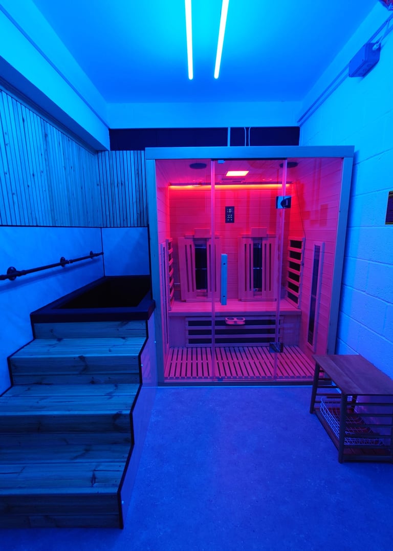 An infrared sauna and cold plunge with blue relaxing lighting