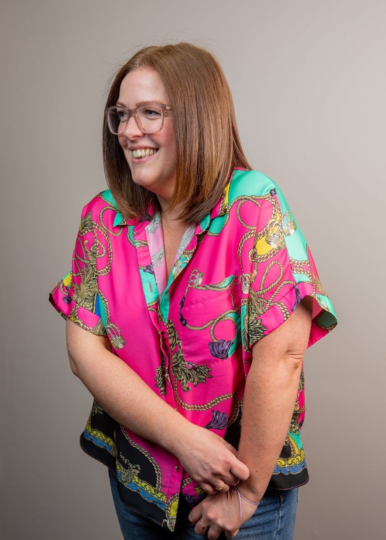 Photo of gabi, founder of the leopard  mind, looking to the left smiling.