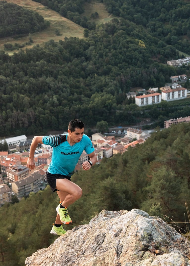 a man running on a mountain trail