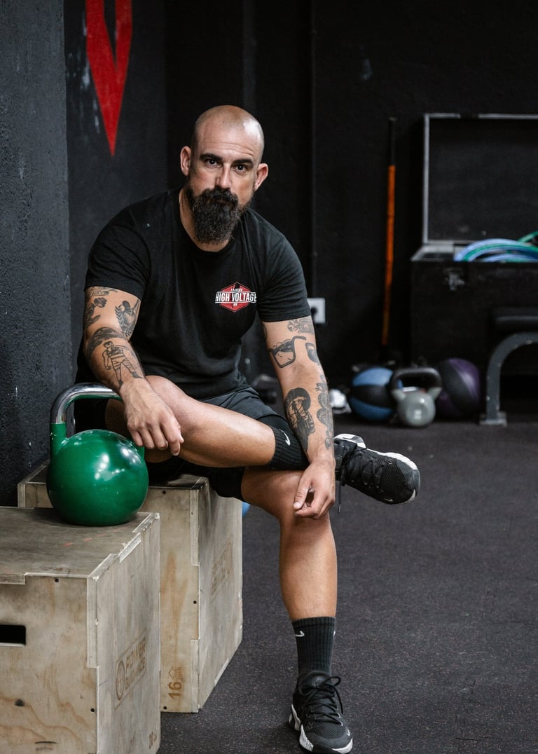 a man with a beard and a beard sitting on a bench