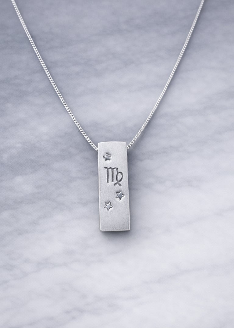 Handmade 999 silver Virgo zodiac necklace with a vertical bar pendant on a marble surface.