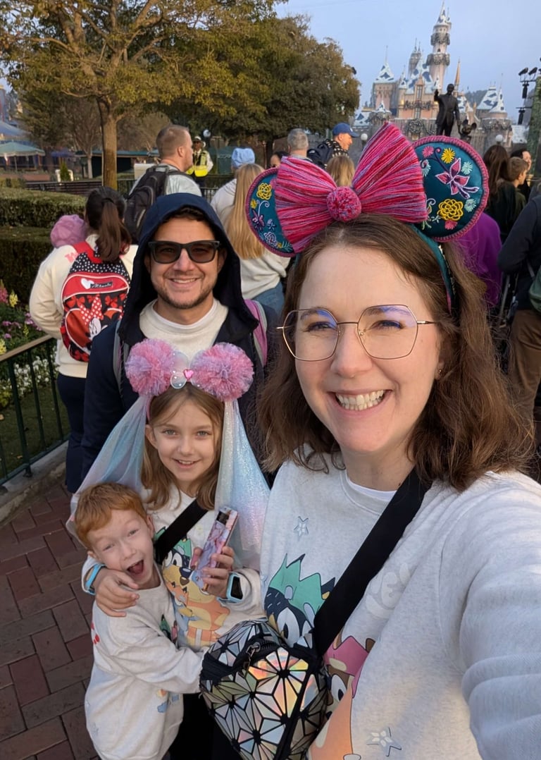 Katie Matzenbacher, Travel Agent, and her family in front of Sleeping Beauty Castle in Disneyland
