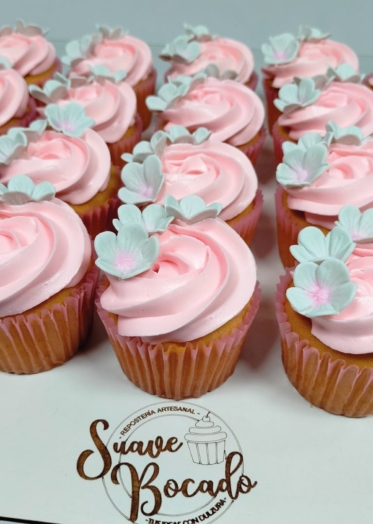 a bunch of cupcakes with pink frosting