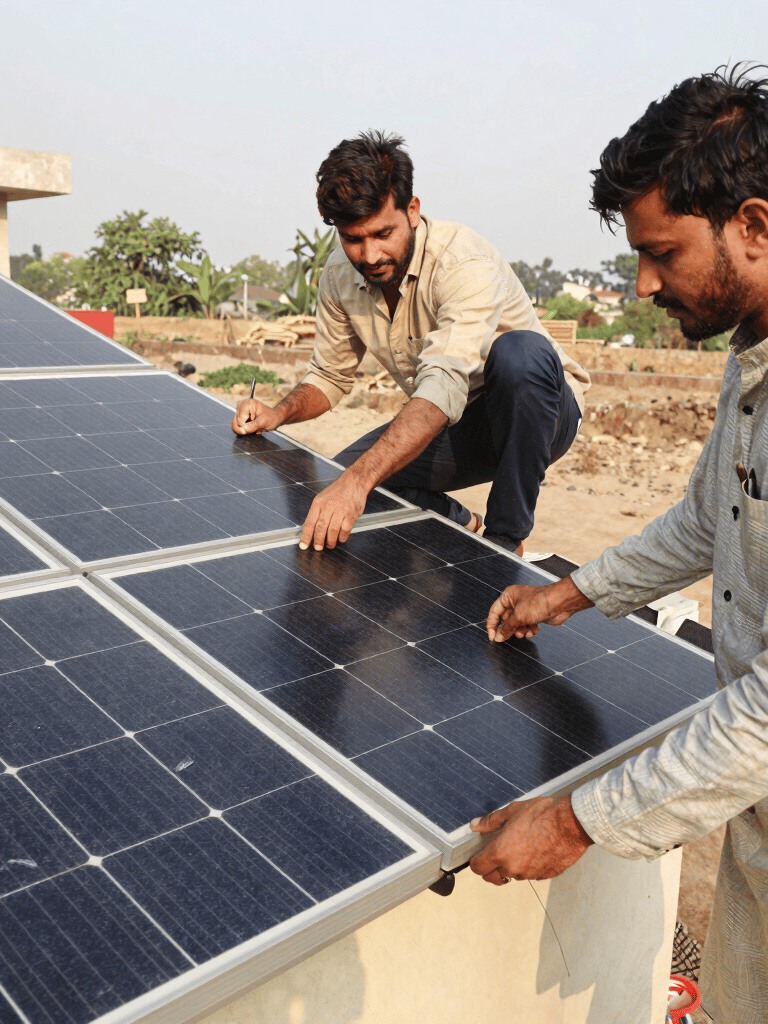 Professional staff installing solar panels on a sunny rooftop in Karachi.