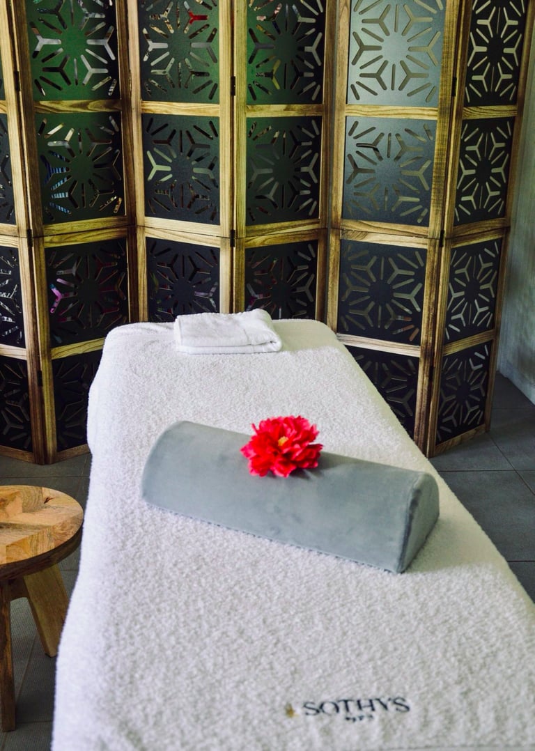 a massage room with a flower on the table