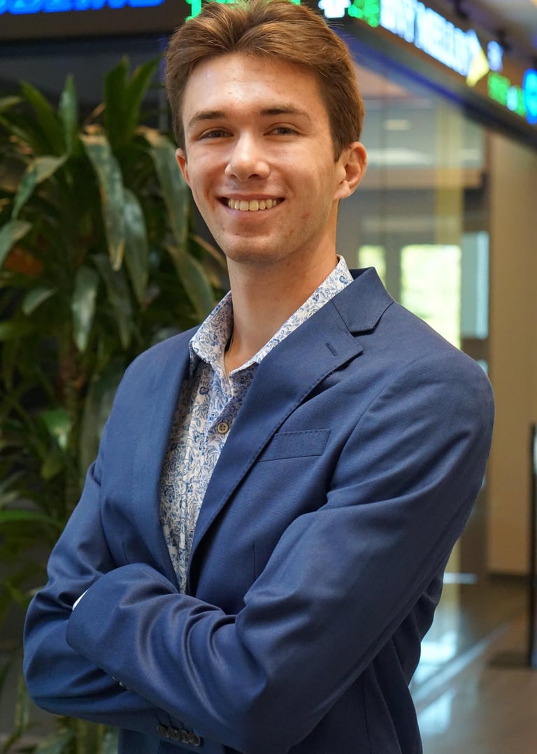 A headshot of Luke Gilmore in a suit.