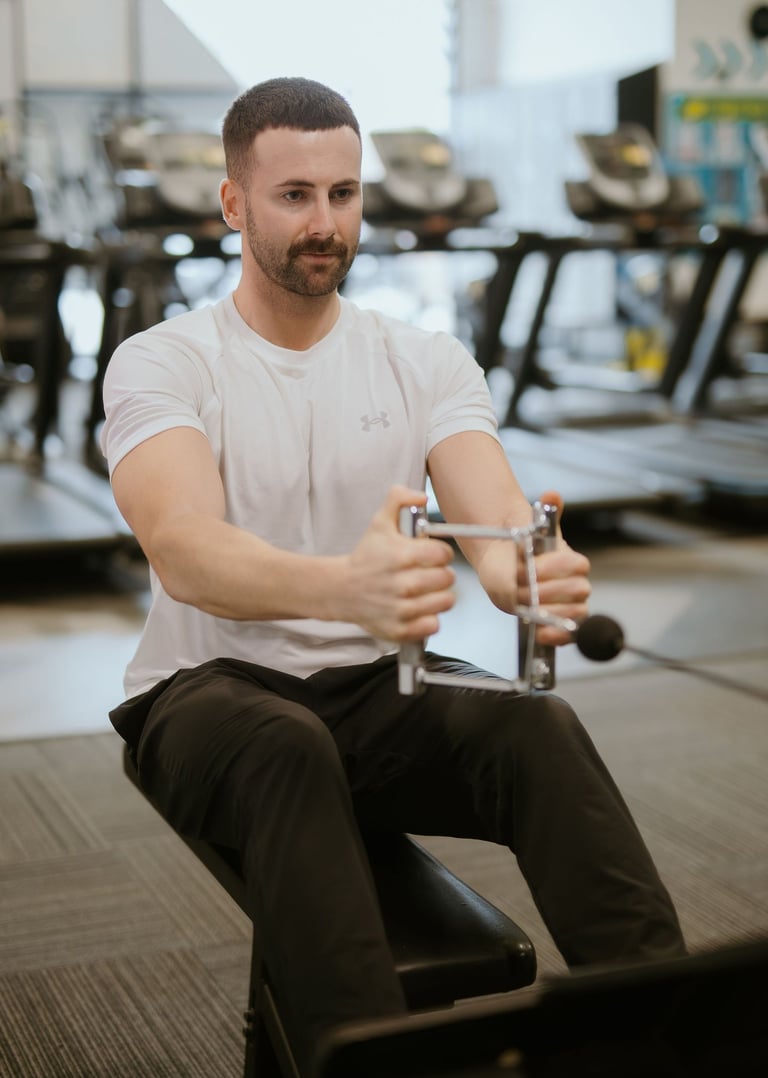Person performing weighted row in Leamington Spa gym, focused on strength and back activation