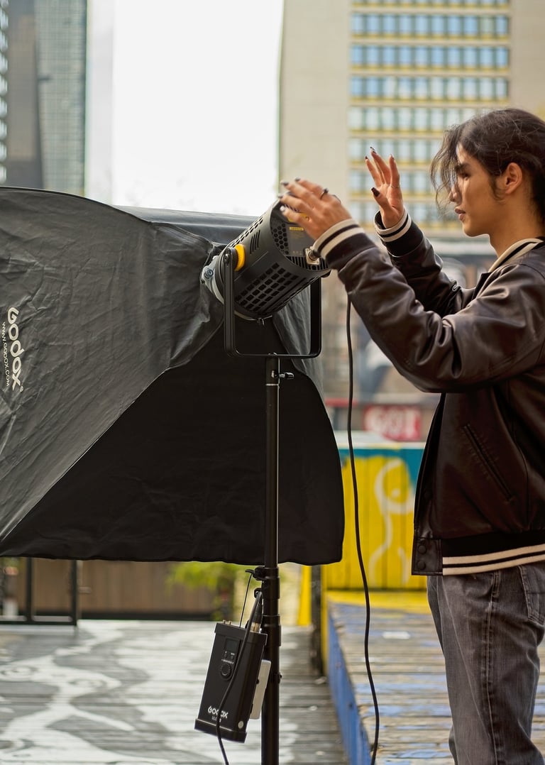 Youth setting up a video light